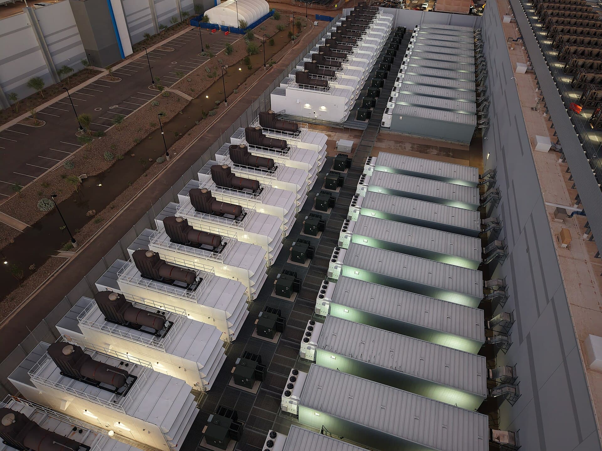 Aerial view of rows of data center backup generators at dusk